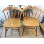 LOCATED AT GRESLEY A pair of modern pine kitchen armchairs, in the style of captains chairs