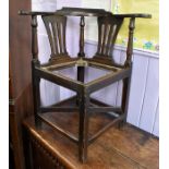 A George III joined oak corner chair, fitted with cross-stretchers, square legs