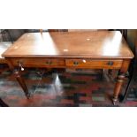 ***LOCATED AT GRESLEY**** A 19th Century mahogany two drawer writing desk, raised on turned legs,