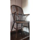 ***LOCATED AT GRESLEY****An early 19th Century spindle back country armchair, curved arm supports,