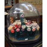 A Victorian woolwork basket of flowers, the flowers hand made with various colours, in a wicker