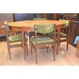 A 1970's oval teak dining table, in the G Plan style, raised on tapered legs, the table forming a