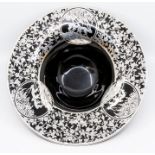 An early 20th Century black glass bowl with white metal mount to border, the openwork mount with