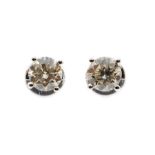 A pair of diamond and 18ct white gold solitaire stud earrings, the round brilliant cut diamonds