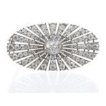 A diamond set platinum brooch, the oval form set to the centre with an old cut diamond approx 0.