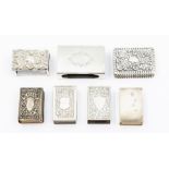 A collection of seven silver match box holders: one plain, three engraved decoration and three