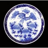 A Chinese blue and white charger, decorated with tree and shrubs within border, character mark to