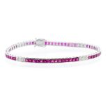 A ruby and diamond 18ct white gold line bracelet, comprising channel set square cut rubies with