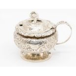 A George IV large circular mustard pot and cover, bulbous body and cover chased and engraved with