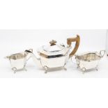 A George VI silver three piece shaped tea service comprising teapot, sugar bowl and milk jug,