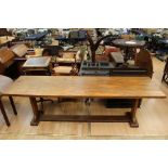 An early 20th Century oak long table, of traditional Arts and Crafts design, the top raised on