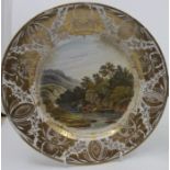 A Derby named-view plate, painted with cows in a river valley, titled to base 'In South Wales', gilt