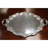 An Edwardian monumental two handled silver tray, the raised sides punctuated with rocaille