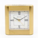 A Tiffany & Co brass alarm clock; and a Estyma travel clock (2)