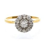 An Edwardian diamond set 18ct gold cluster ring, comprising a central old cut claw set to the