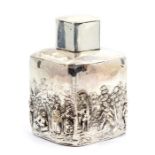 An Edwardian silver tea caddy, shaped square body chased, repousse and engraved with a pastoral