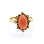 A coral and diamond 18ct yellow gold ring, comprising an oval coral set to the centre within a