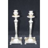 A pair of Empire style 800 standard silver candlesticks, detachable sockets abover tapering stems on