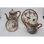 A Japanese satsuma part tea service including teapot, sugar bowl, saucers and plates, stamped on