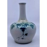 Ruskin Pottery: A Ruskin Pottery globe and shaft vase with high fired cream glaze with a green