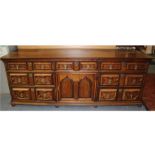 An early 18th Century joined oak dresser base, circa 1710, fitted with seven drawers and a central