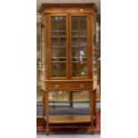 An Edwardian mahogany Sheraton style display cabinet, circa 1905, fitted with two glazed doors, each
