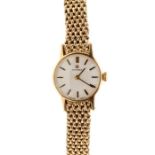 Omega- a ladies 9ct gold Omega watch, silvered round dial, approx 17mm, gold tone baton markers,
