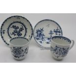 Two 18th century Worcester blue and white tea cups, painted with floral sprays; and two blue and