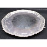 An Elizabeth II silver salver, shaped circular with gadroon rim, on three scroll feet, by Viner's,