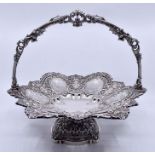 A Victorian silver swing handled fruit basket, floral shaped with scrolling border above sections of