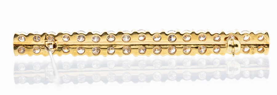 An 18ct gold and diamond brooch, comprising alternate double diamond set and gold bar details, set - Image 2 of 2