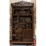 A late 19th century Chinese Zitan wood display cabinet, fitted with an arrangement of shelves,