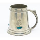 Archibald Knox for Liberty & Co. a Tudric pewter and enamel tankard, with three stylised flowers