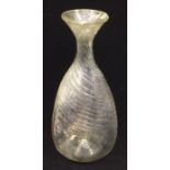 A Medieval, circa mid 14th Century, glass flask with wrythen body, flared mouth and rough pontil