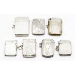 Seven various late 19th and early 20th Century silver vesta cases, three plain, three engraved and