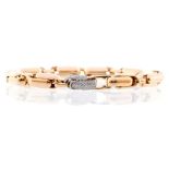 An 18ct gold and diamond bracelet, comprising lozenge links with diamond set fold over clasp,
