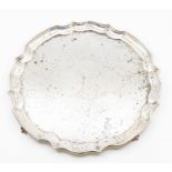 An Elizabeth II silver salver, piecrust rim on four ball and claw feet, by AE Jones, Birmingham,