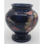 A Moorcroft pedestal ovoid vase, Orchid pattern, blue ground, impressed marks to base, approx 9cm