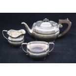 An Elizabeth II silver three piece tea service comprising teapot, milk jug and sugar bowl, plain