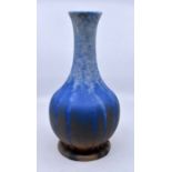 Ruskin Pottery: A Ruskin Pottery globe and shaft vase in a blue over orange crystalline glaze,