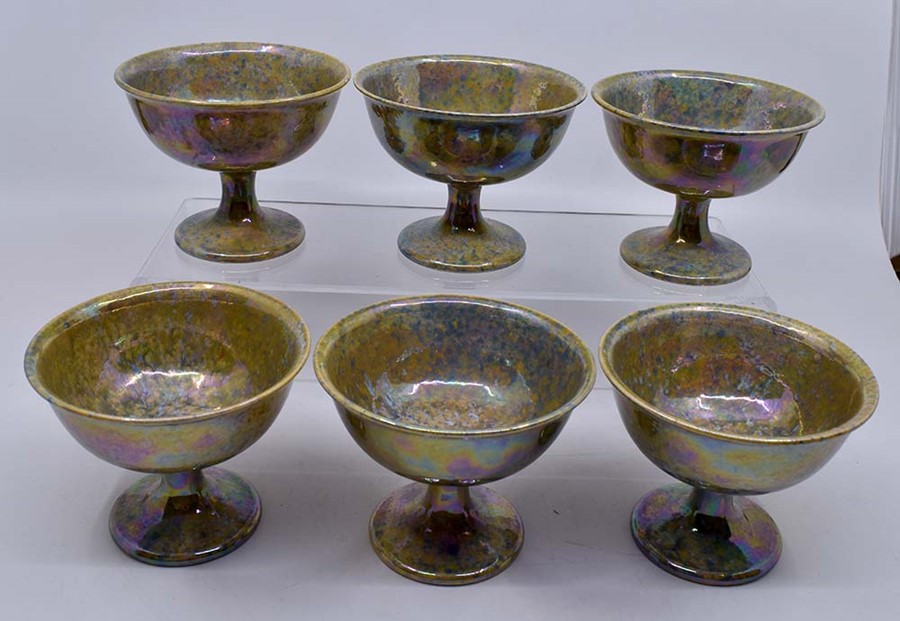 Ruskin Pottery: A Ruskin Pottery set of 6 pedestal footed bowls with speckled lustre glaze, height