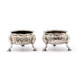 A pair of George III silver circular salts, flared rim, above body chased with scrolls, flowers