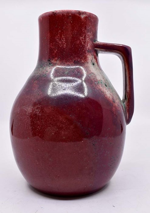 Ruskin Pottery: A Ruskin Pottery single handled jug with sang de boeuf and green high fired glaze,