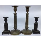 Two pairs of early to mid 19th Century candle sticks, small bronze along with brass Indian Empire