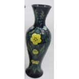A Moorcroft slender baluster vase, Buttercup pattern, designed by Sally Tuffin, circa 1993,