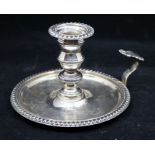 A Georgian style candlestick holder, gadroon rim, baluster stem with detachable sconce, shaped