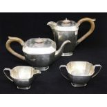 A George VI Art Deco style silver four piece tea service to include teapot, hot water jug, sugar