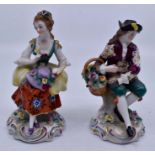 A pair of Continental porcelain figures modelled as fish or fruit sellers in 18th Century style,