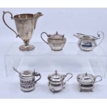 A collection of various silver mustard pot and covers, various dates and makers, all with blue glass