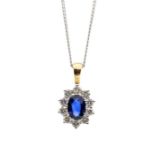 A sapphire and diamond 18ct gold cluster pendant, comprising a central sapphire weighing approx 1.